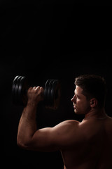 man taking dumbbells in a gym
