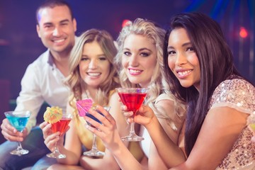 Obraz na płótnie Canvas Happy friends with cocktails