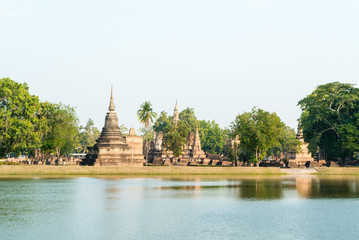 Old pagoda with lake in the temple at Sukhothai Historical Park in Sukhothai Province, Thailand