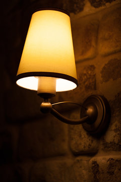 lapm shining on a stone wall