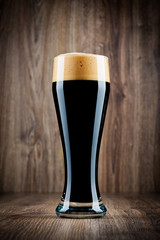 Glass of beer on wooden background