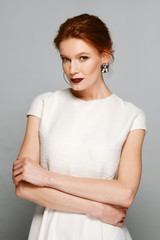 Fototapeta premium stylish fashion model with red mat lips and gemstone earrings