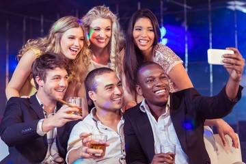 Happy friends taking selfie