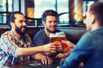 happy male friends drinking beer at bar or pub