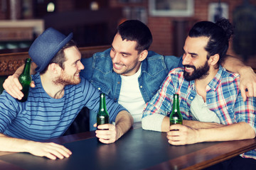 happy male friends drinking beer at bar or pub