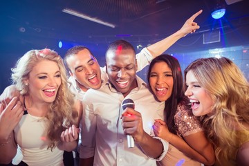  Happy friends singing at the karaoke - 109791828