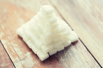 close up of white sugar pyramid on wooden table