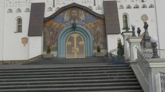 Entrance to Dormition Cathedral Pochiv Lavra Flying Birds Pochaiv Ukraine Motion up the Stairs Image of Jesus and Saints With Halos Around the Door
