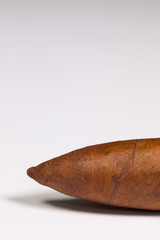 Detail of luxury Cuban cigar on the white table