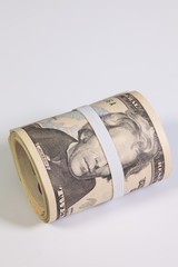 The roll of dollar bills with plastic band over the eyes
