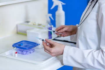 A woman vet preparing syringes