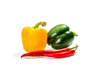  yellow and green bell pepper with chili pepper on a white background