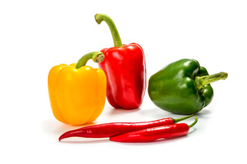 red, yellow and green bell pepper with chili pepper on a white background