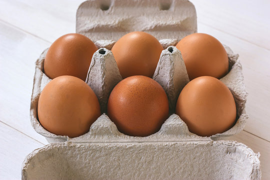 Fresh brown eggs in a carton