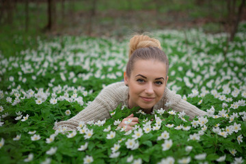 Beautiful sensual lady lying on flower meadow