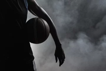 Fototapeten Closeup of a man holding a basketball © WavebreakMediaMicro