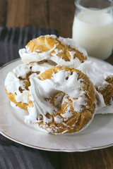 Meringue donuts served with a glass of milk