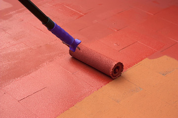 Contract painter painting a floor on color red