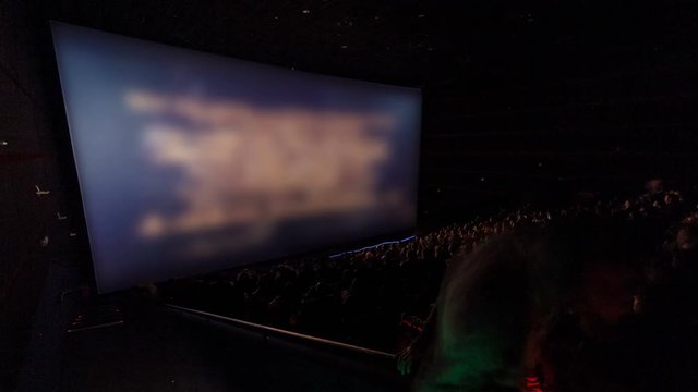 viewers watch motion picture at movie theatre timelapse