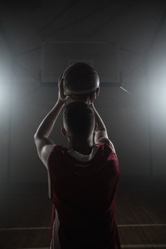 Portrait of basketball player front the back preparing to score