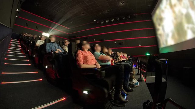 viewers watch motion picture at movie theatre timelapse