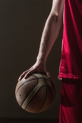 Fototapeta premium Close up on basketball held by basketball player