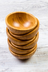 Top view of wooden bowl on wooden background