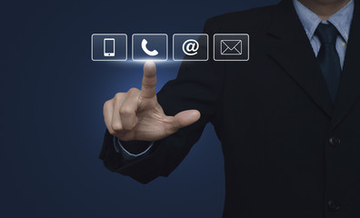 Obraz premium Businessman pressing telephone, mobile phone, at and email butto
