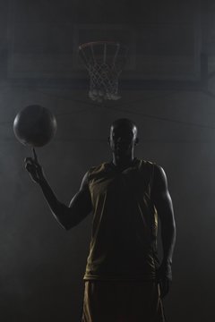 Basketball player turning the ball on his finger 