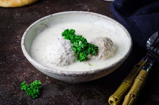 Kibbeh bil laban - arabian yogurt soup with stuffed bulgur cutletson dark background. Selective focus
