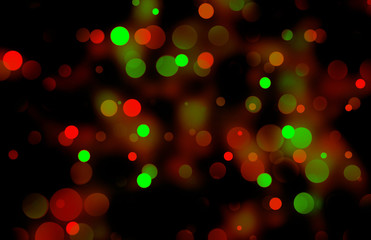 Festive bokeh illumination with warm red and green lights on black