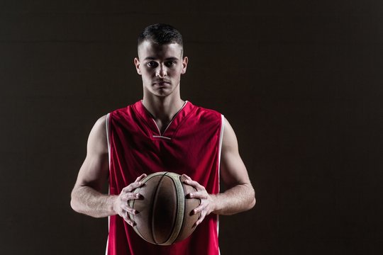 Portrait Of Basketball Player Holding A Ball