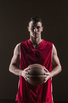 Portrait of basketball player holding a ball