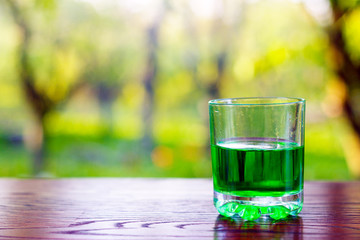 Glass of green absinth