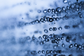 rain drops of water close-up macro on a blue background