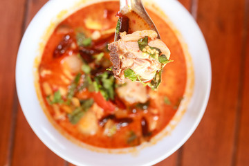 close up  scoop soup with spoon on wood table background  ,focus