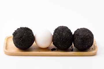 Salted eggs on wooden plate white background 