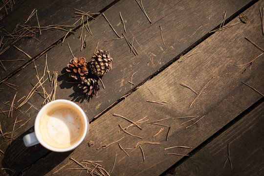Cup of coffee and pine cones