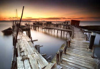 Ancient fishing pier with warm and beautiful sunset - 109806451