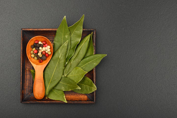 Bay leaves and pepper on black chalkboard