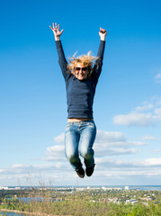 Girl in a jump over a cliff