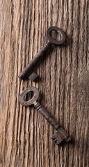 Top view on wooden board with two old keys