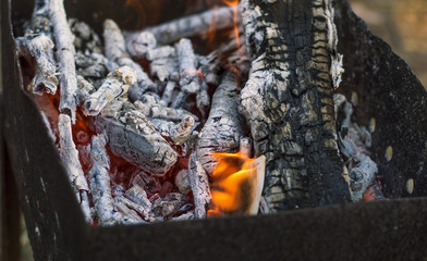burning firewood in the grill, coals, fire