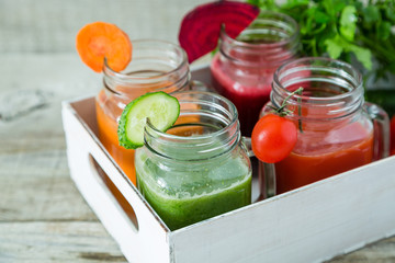 Selection of colorful vegetable juices in glass jars