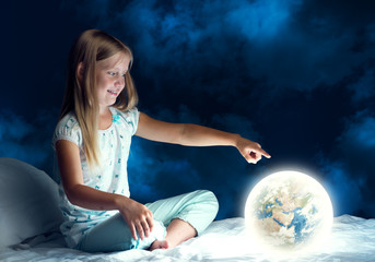 Girl in her bed and glowing globe