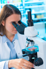 Quality control of food products. Young woman in chemical labora