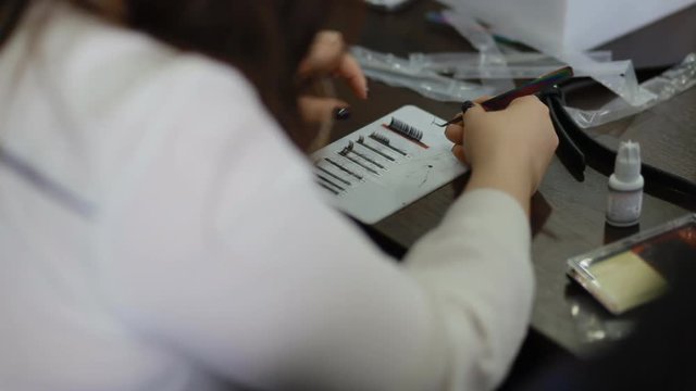 Female lashmaker work on tablet