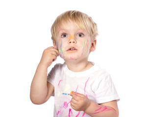 Portrait of a cute blond boy enjoying her painting.