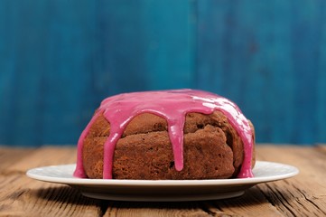 Homemade chocolate cake with violet sugar icing