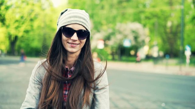 Portrait of happy, hipster woman standing in city
